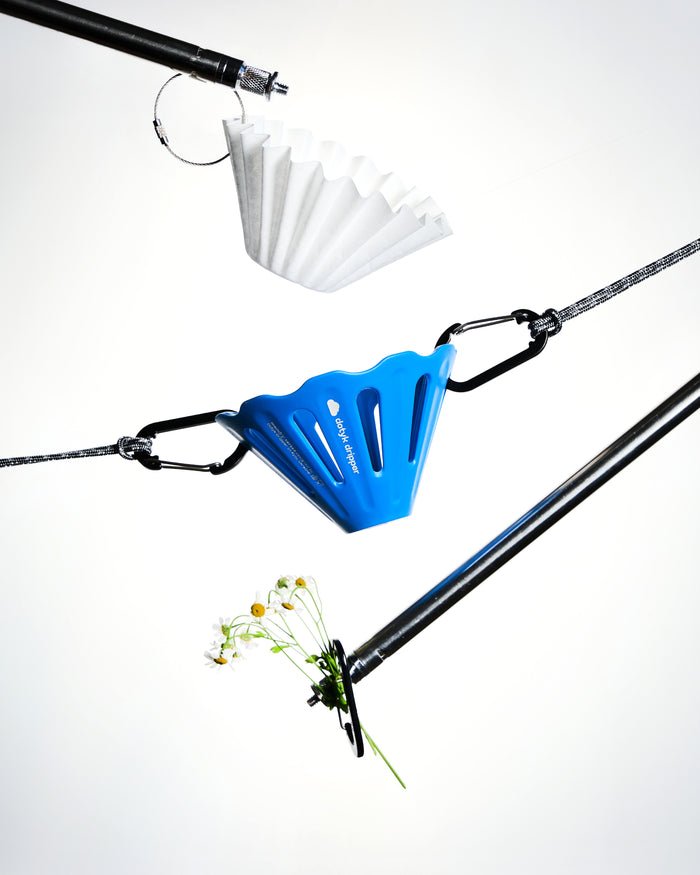 Blue Dotyk Mandry travel dripper hanging from a carabiner
